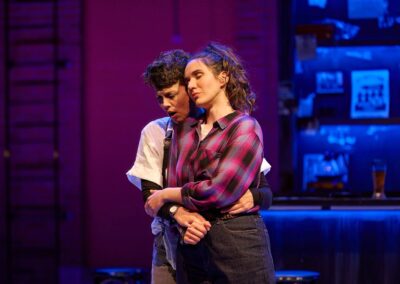 Two women embracing on stage. From the opera "Pomegranate" with the Canadian Opera Company 2023.