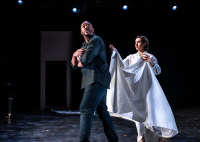 Modern opera performance with man and woman holding white fabric.